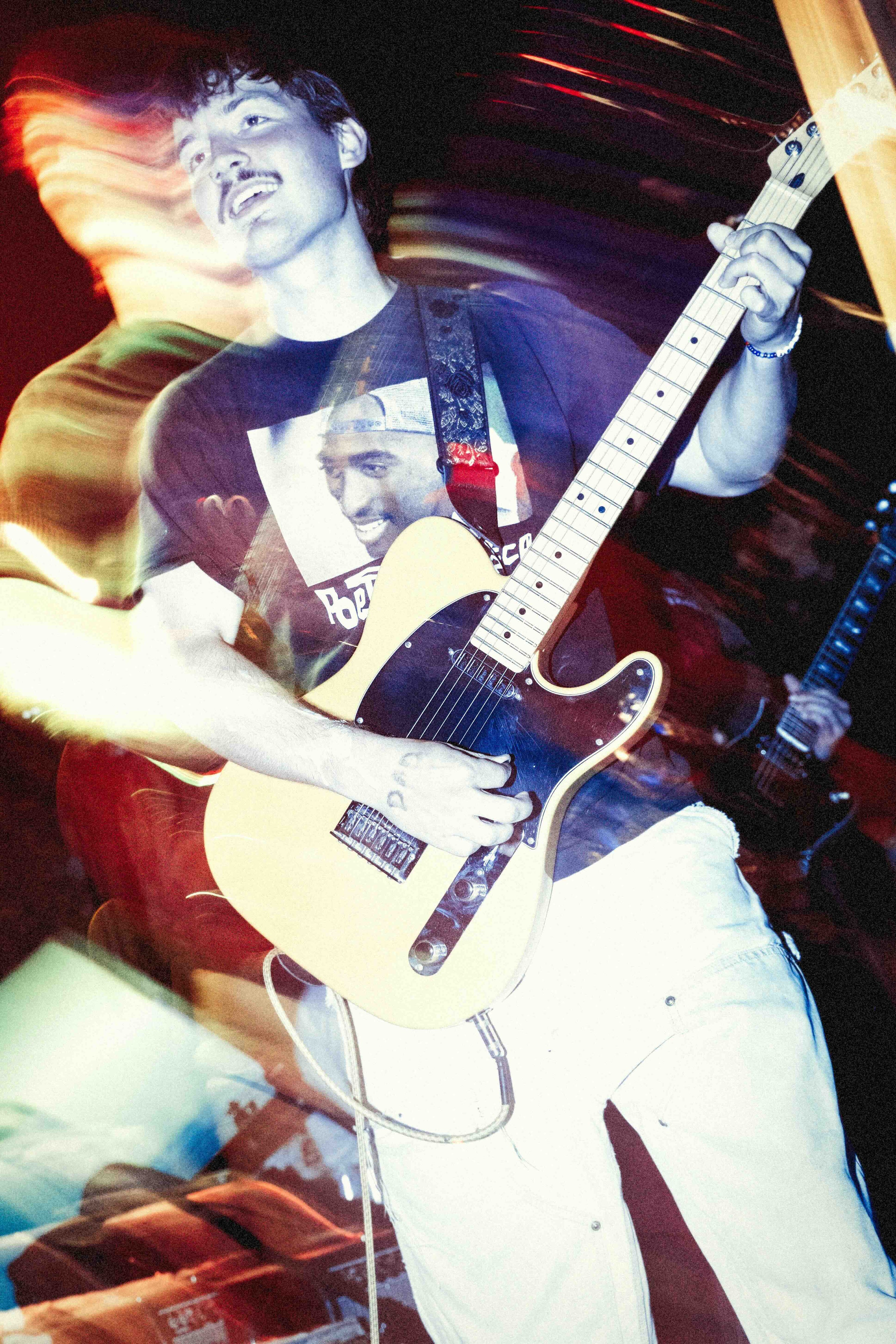 Person playing a guitar with a blurred background